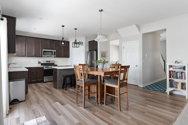 dining space featuring sink and light hardwood / wood-style flooring