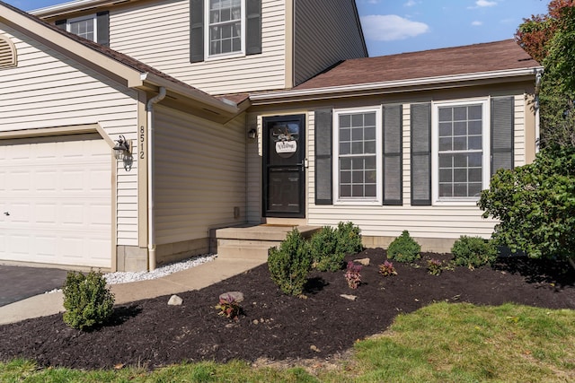 doorway to property with a garage