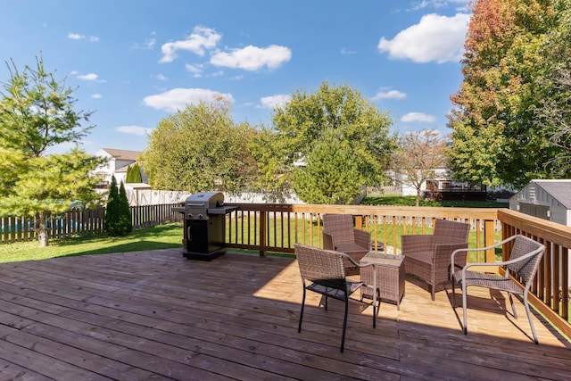 wooden terrace featuring a lawn and a grill