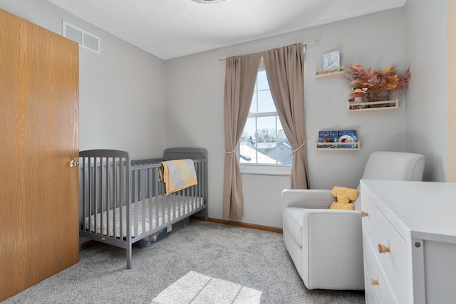 carpeted bedroom featuring a crib