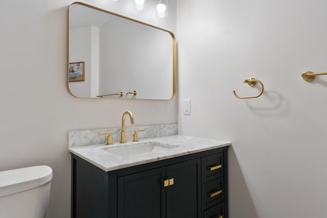 bathroom with toilet and vanity