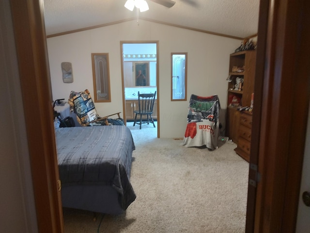 carpeted bedroom featuring lofted ceiling, ceiling fan, a textured ceiling, and crown molding