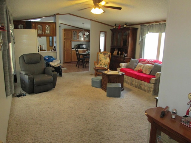 living room with ceiling fan, carpet, and vaulted ceiling