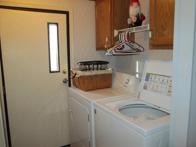 laundry room featuring cabinets and separate washer and dryer