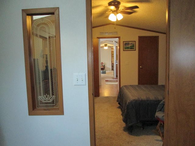 bedroom featuring carpet floors, visible vents, vaulted ceiling, and ensuite bathroom