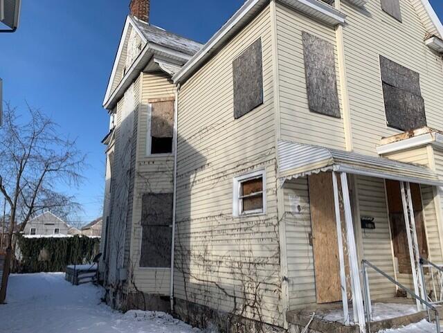 view of snow covered exterior with a porch