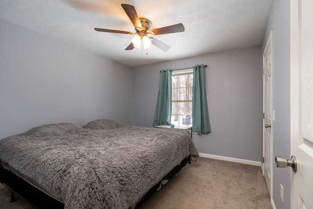 bedroom featuring light colored carpet, baseboards, and ceiling fan