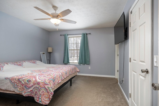 bedroom with carpet flooring, ceiling fan, a textured ceiling, and baseboards