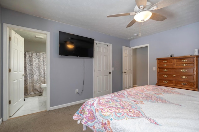 bedroom featuring baseboards, carpet floors, ceiling fan, a closet, and connected bathroom