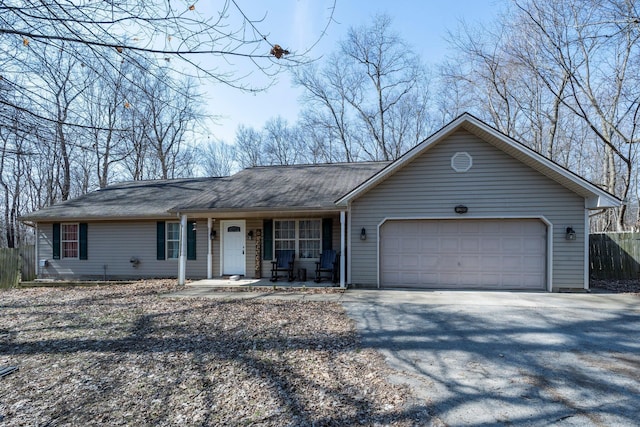 single story home featuring aphalt driveway, a garage, covered porch, and fence