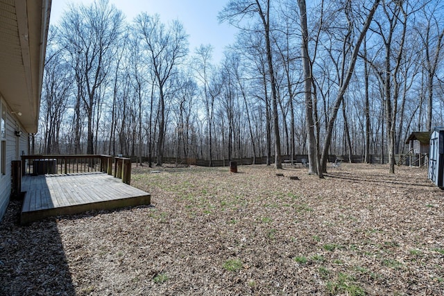 view of yard with cooling unit and a wooden deck