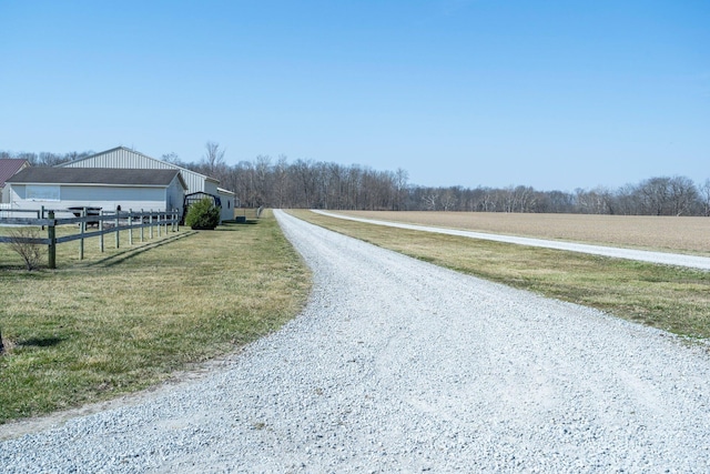 view of road featuring a rural view and gravel driveway