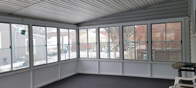 unfurnished sunroom featuring vaulted ceiling