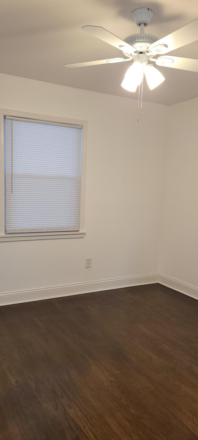 unfurnished room featuring ceiling fan and dark hardwood / wood-style flooring