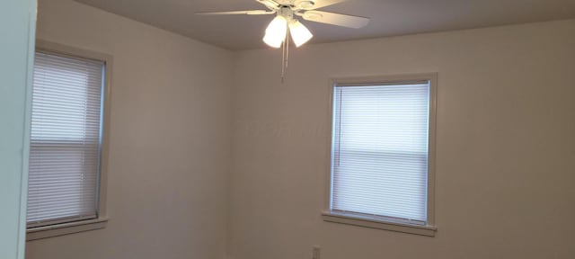 unfurnished room featuring a wealth of natural light and ceiling fan