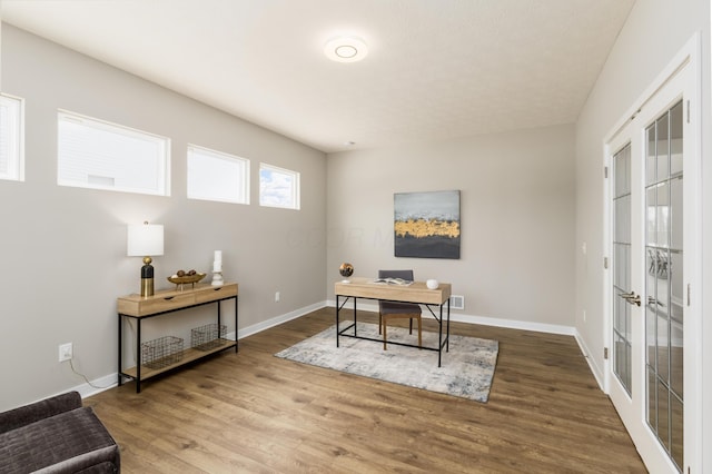 office space featuring french doors and hardwood / wood-style flooring