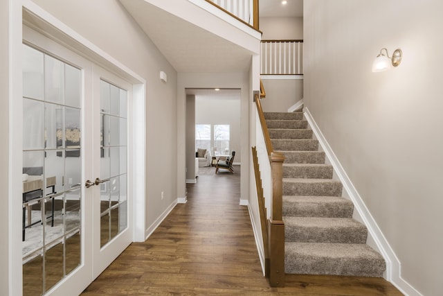 foyer entrance with french doors and dark wood-type flooring