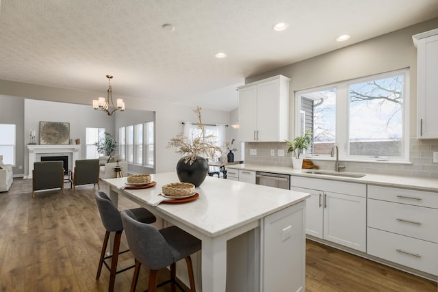 kitchen with white cabinets, stainless steel dishwasher, and sink