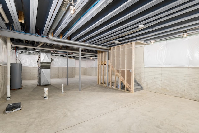 basement featuring heating unit and water heater