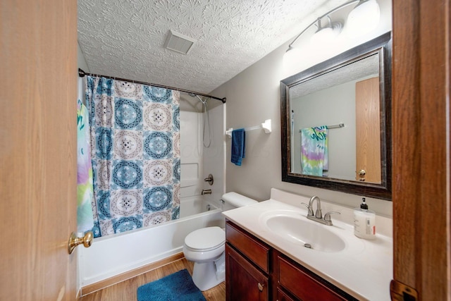 full bathroom featuring shower / bathtub combination with curtain, a textured ceiling, toilet, vanity, and hardwood / wood-style flooring