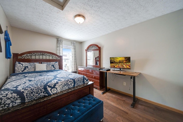 bedroom featuring wood-type flooring and a textured ceiling