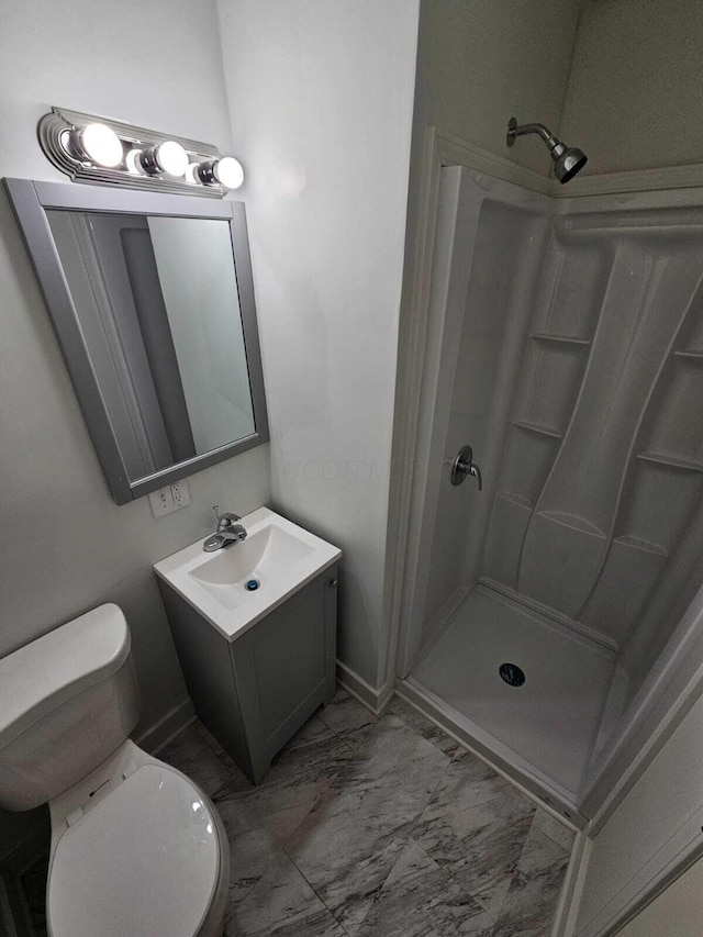 bathroom with a shower, vanity, and toilet