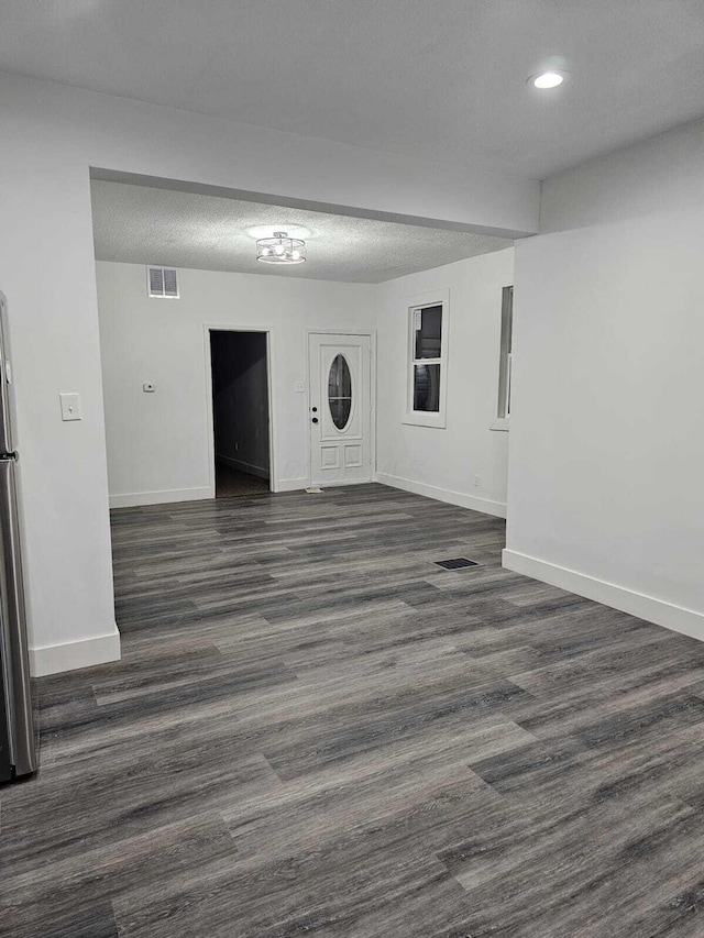 unfurnished living room featuring dark wood-type flooring