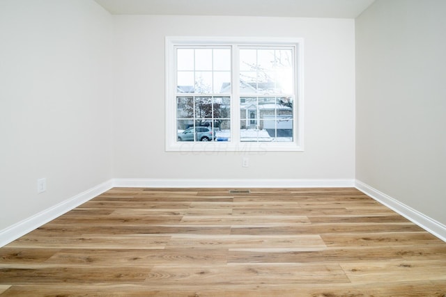 spare room with light wood-type flooring