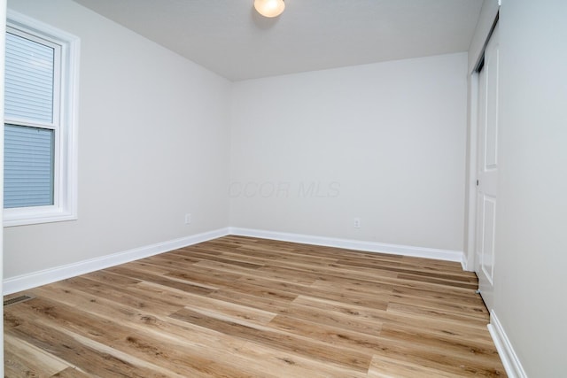 unfurnished room with hardwood / wood-style flooring