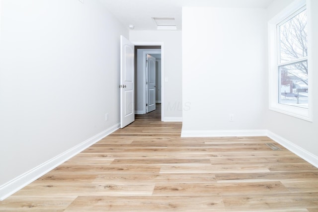 empty room featuring light hardwood / wood-style flooring and plenty of natural light