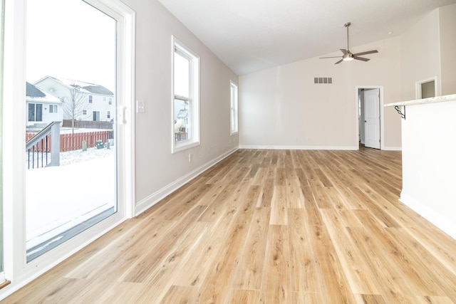 unfurnished living room featuring ceiling fan, light hardwood / wood-style floors, and vaulted ceiling