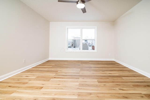 empty room with ceiling fan and light hardwood / wood-style floors