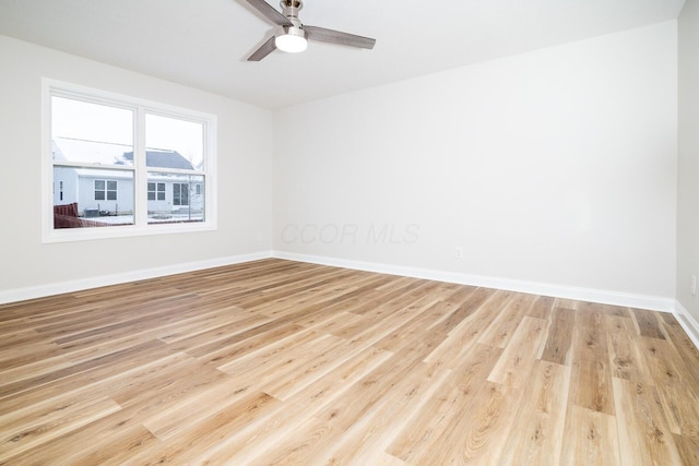 spare room featuring light hardwood / wood-style floors and ceiling fan