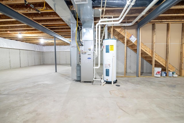 basement featuring electric water heater and heating unit