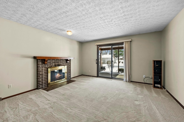 unfurnished living room with a textured ceiling, a fireplace, and light carpet