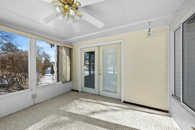 unfurnished sunroom with ceiling fan and french doors