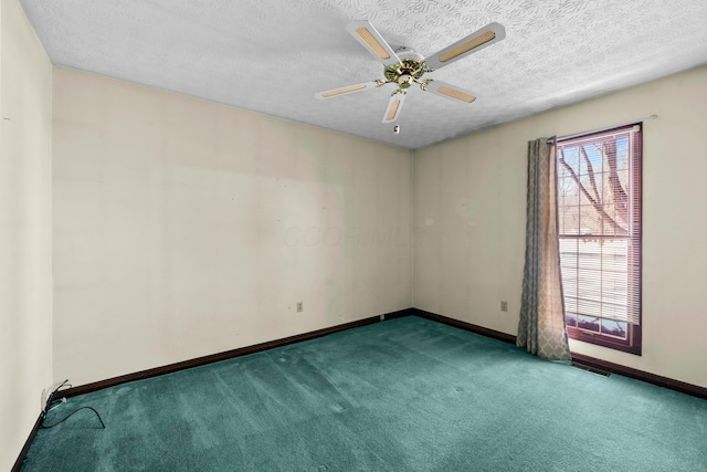 carpeted spare room with ceiling fan and a textured ceiling