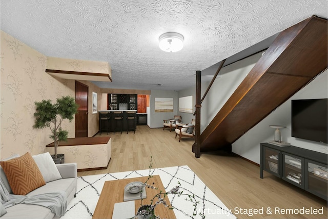 living room with hardwood / wood-style floors and a textured ceiling