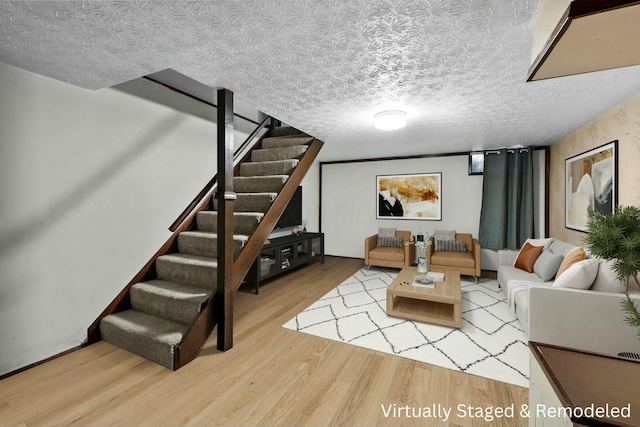 living room with hardwood / wood-style flooring and a textured ceiling