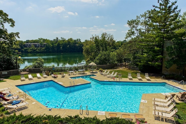 view of swimming pool with a patio area and a water view