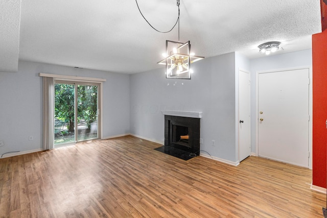 1301 Lake Shore Dr Unit 199, Columbus, OH 43204 - unfurnished living room with light wood finished floors, a textured ceiling, and a fireplace