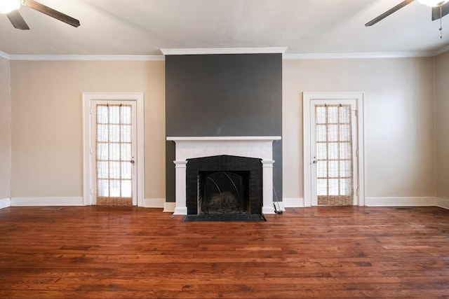 unfurnished living room with ceiling fan, wood-type flooring, ornamental molding, and a fireplace