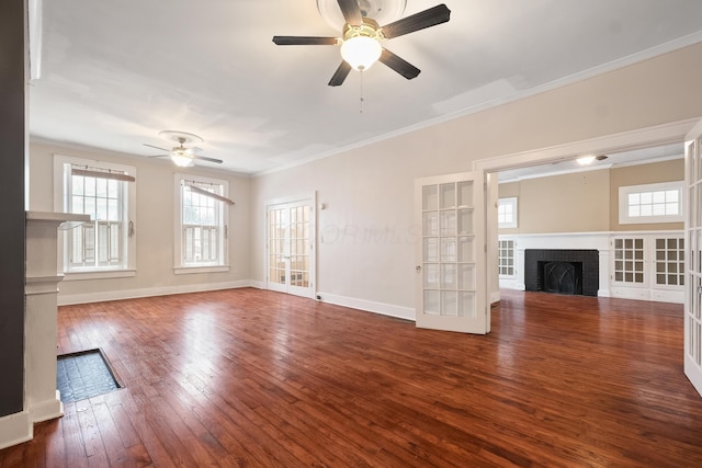 unfurnished living room with french doors, dark hardwood / wood-style floors, a brick fireplace, and crown molding