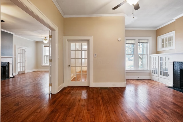 unfurnished living room with crown molding, dark hardwood / wood-style floors, and a brick fireplace