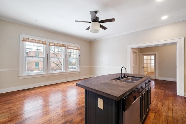 kitchen featuring dishwasher, a center island with sink, sink, ceiling fan, and dark hardwood / wood-style flooring