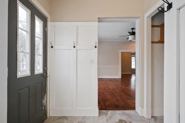 entryway with ceiling fan and a wealth of natural light