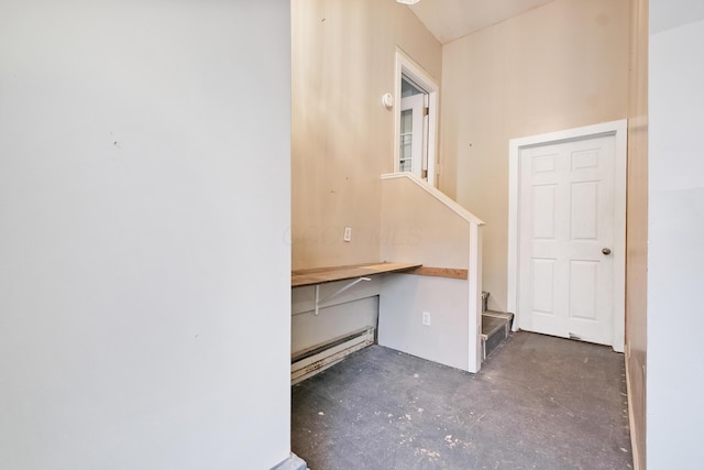 miscellaneous room with built in desk and baseboard heating