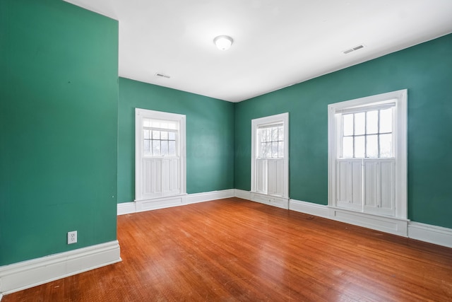 unfurnished room with hardwood / wood-style flooring