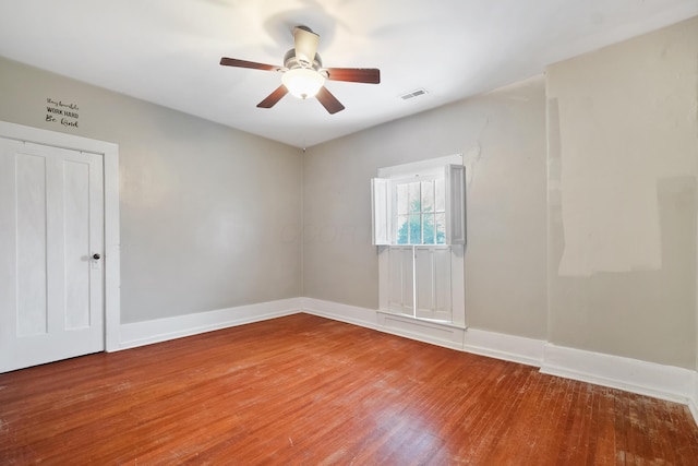 spare room with hardwood / wood-style flooring and ceiling fan