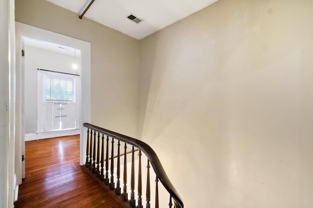 stairway with hardwood / wood-style floors